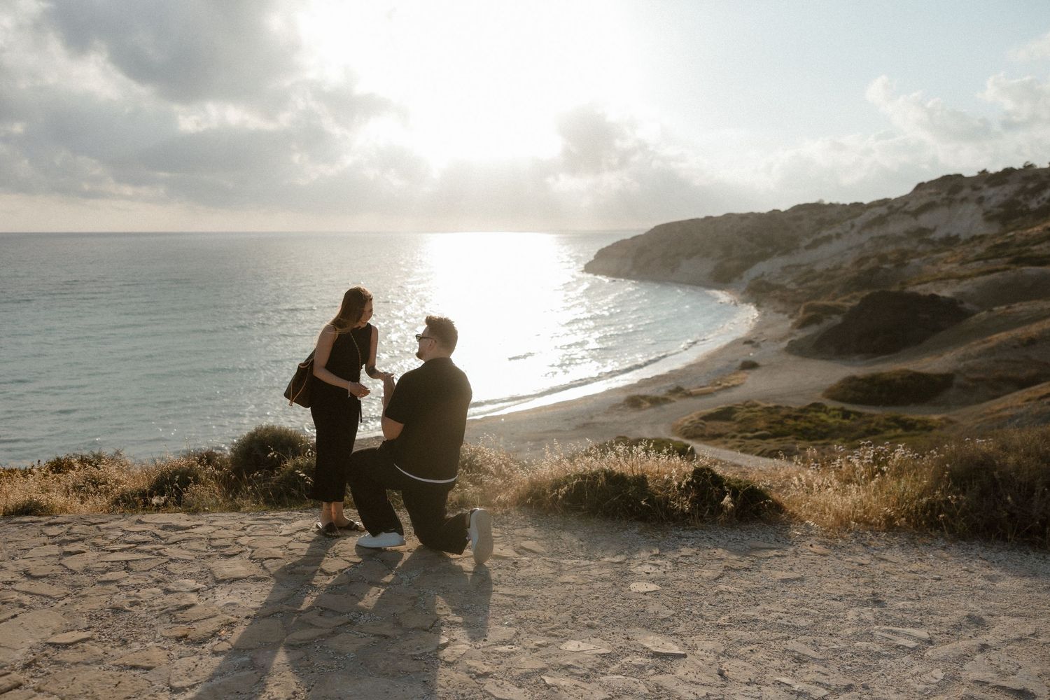 Couple getting engaged on the beach in Paphos, captured by professional photographers with over 10 years of experience.