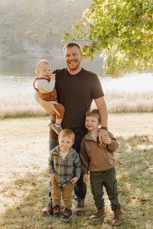 A series of candid outdoor family photos taken in a sun-dappled park with autumn leaves on the ground.