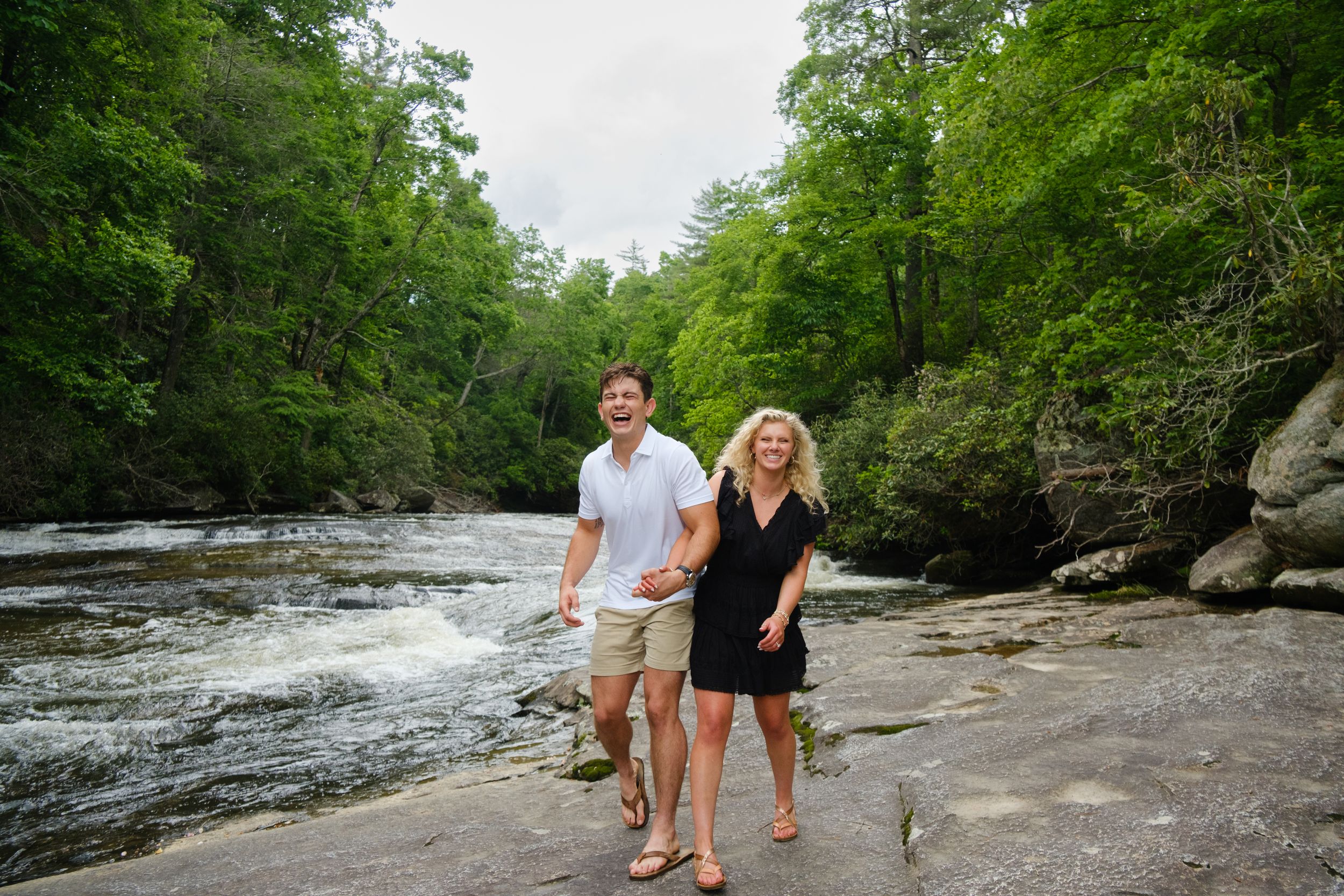 Newly engaged couple hiking near Rainbow Falls in Western North Carolina