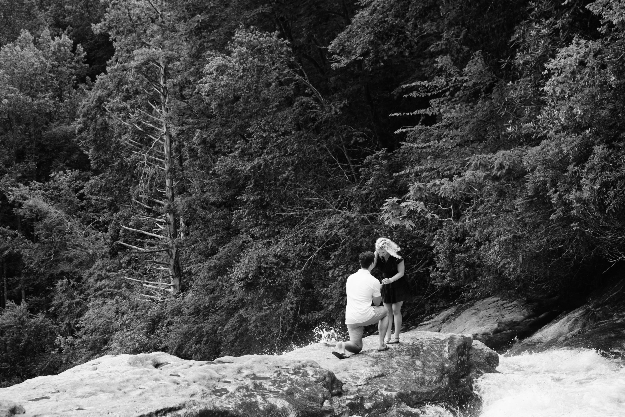 Braydon proposing to Greenlee overlooking Rainbow Falls in Sapphire, North Carolina