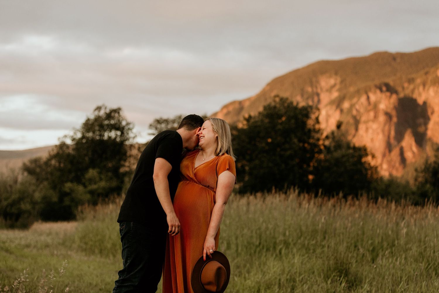 Golden hour family session in North Bend Washington with Washington portrait & wedding photographer walking through a grassy meadow