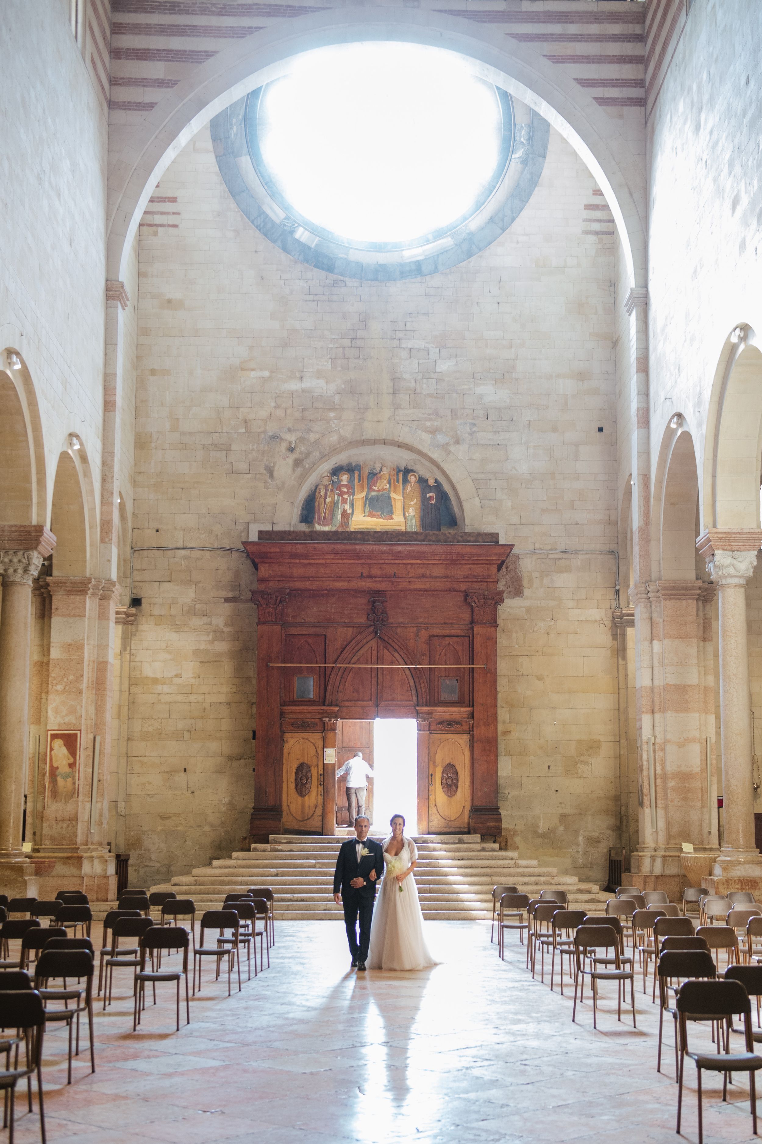 Bride entering Basilica di San Zeno during her wedding ceremony in Verona