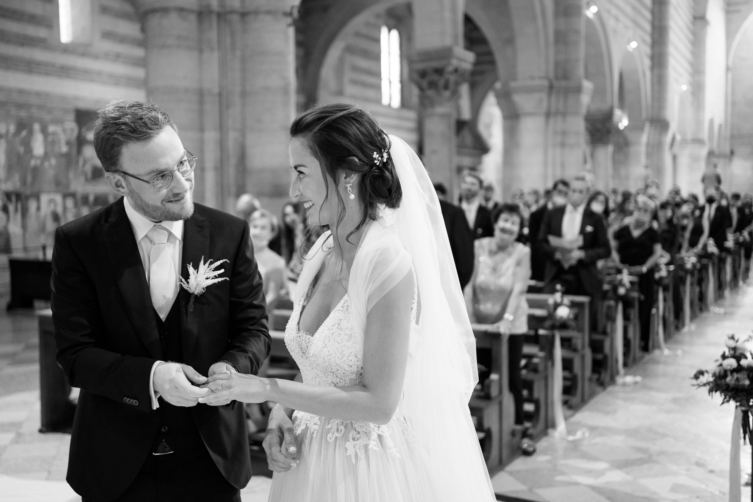 Bride and groom exchanging wedding rings at Basilica di San Zeno in Verona.