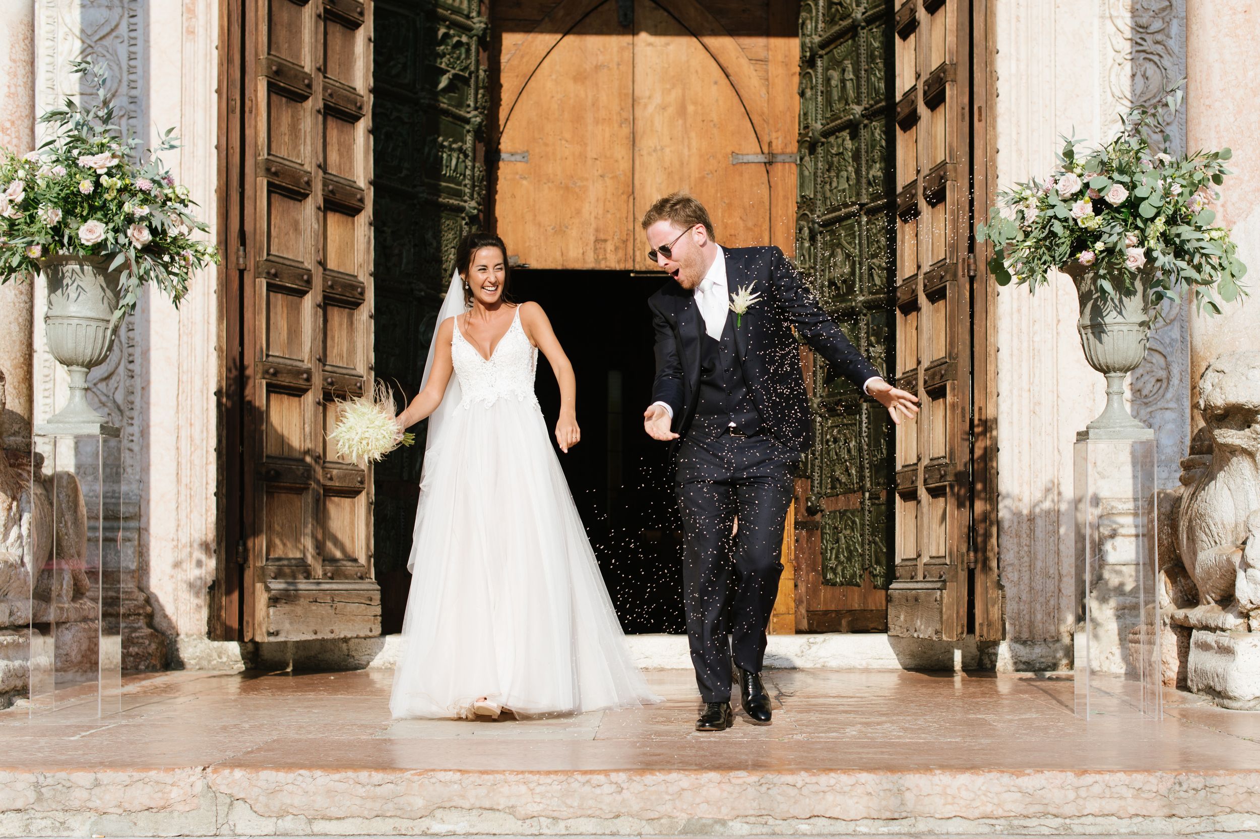 Newlyweds leaving Basilica di San Zeno after their wedding ceremony in Verona