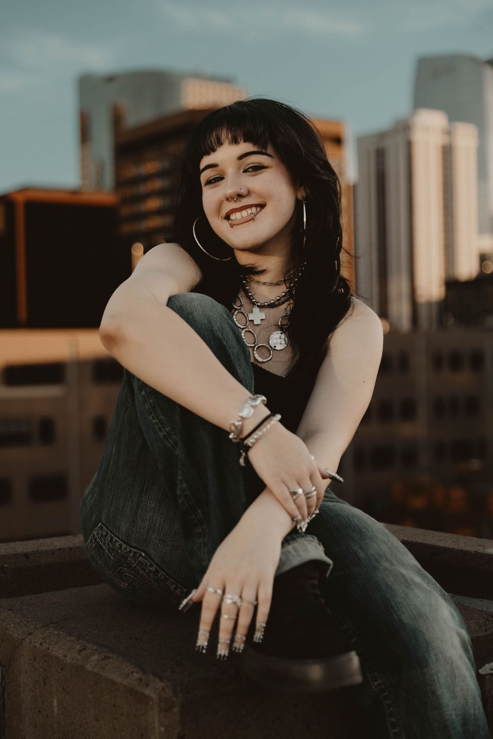 Girl sits on a parking garage for moody, cinematic, urban, portrait, senior photos in Denver, Colorado outside, urban, and nature photos