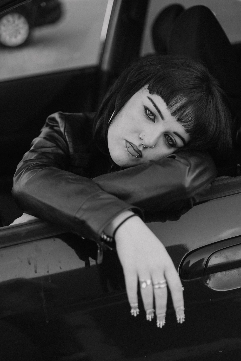 Girl hangs out car for moody, cinematic, urban, portrait, senior photos in Denver, Colorado outside, urban, and nature photos