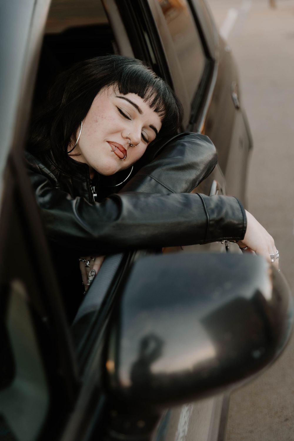 Girl hangs out car for moody, cinematic, urban, portrait, senior photos in Denver, Colorado outside, urban, and nature photos