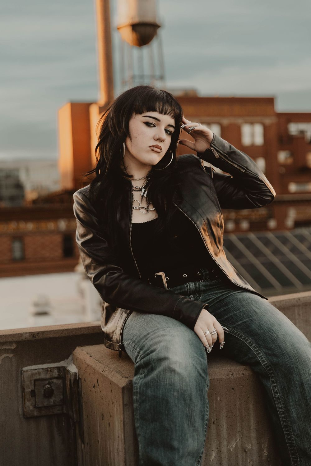Girl sits on a parking garage for moody, cinematic, urban, portrait, senior photos in Denver, Colorado outside, urban, and nature photos