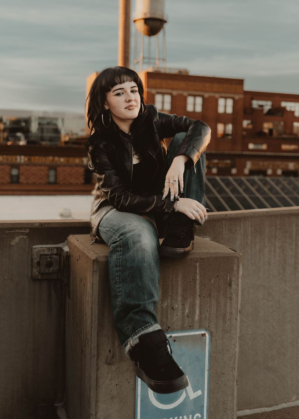 Girl sits on a parking garage for moody, cinematic, urban, portrait, senior photos in Denver, Colorado outside, urban, and nature photos