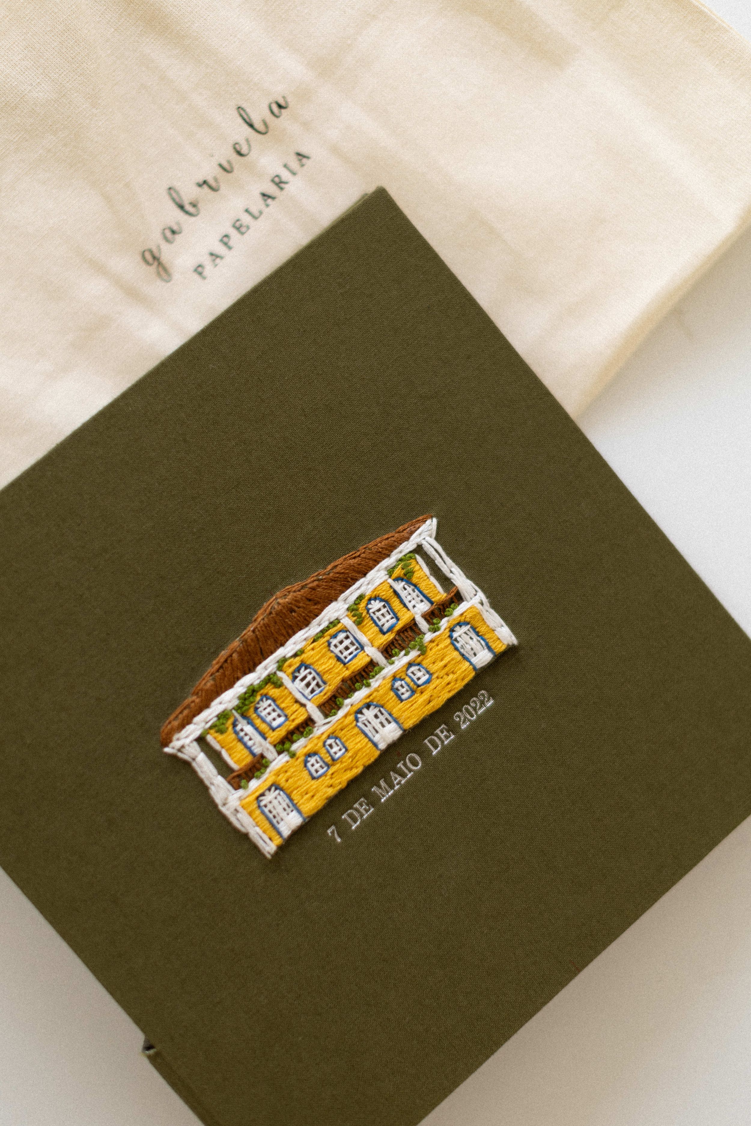 A sequential image series showing a Tiger Bar chocolate snack resting on a dark olive green surface.
