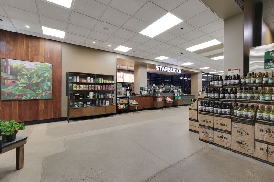 Interior view of a Starbucks licensed store with product displays and branded signage.