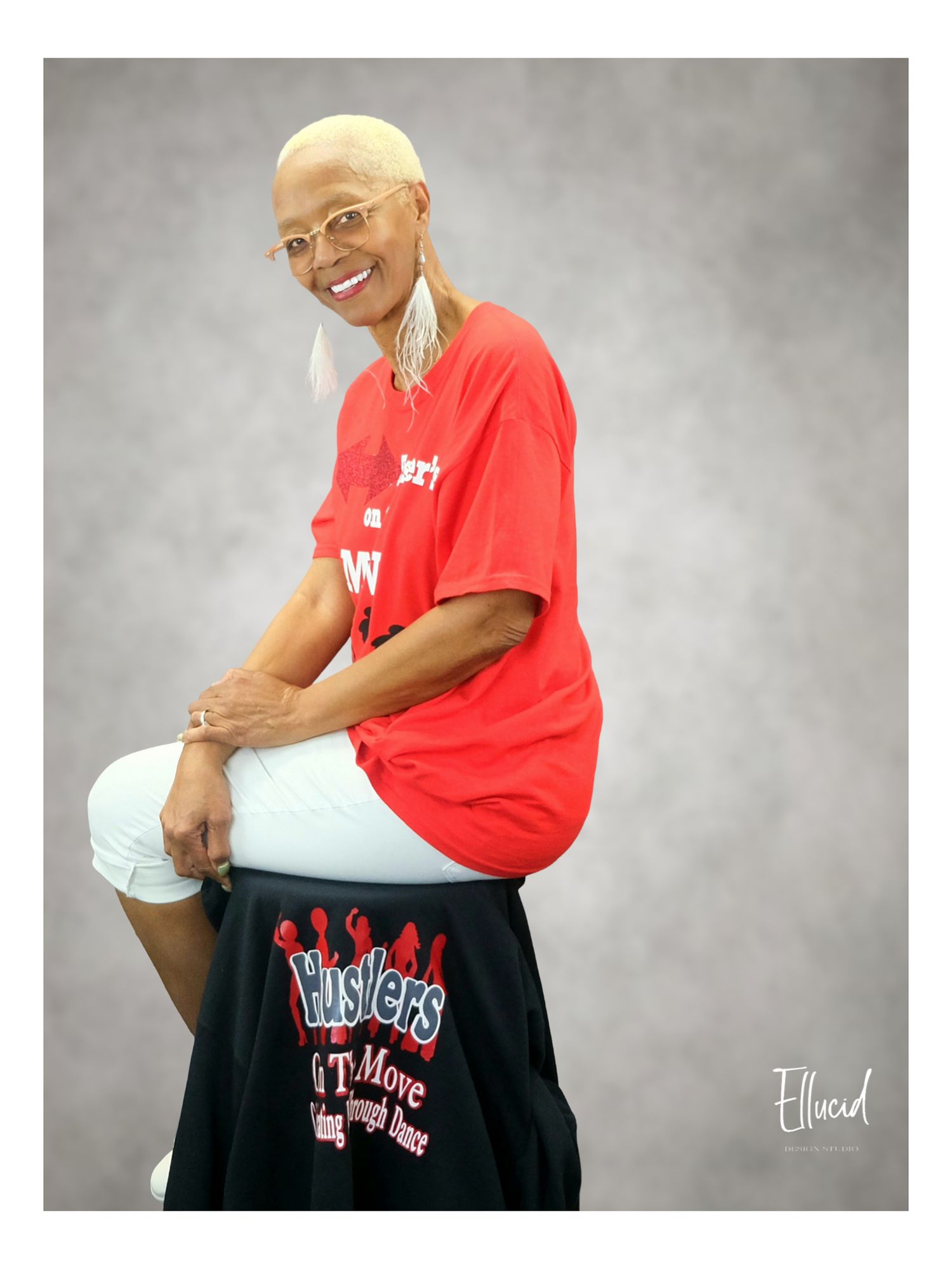 Studio portrait against showing someone in a red t-shirt by Ellucid Design Studio Genesee County