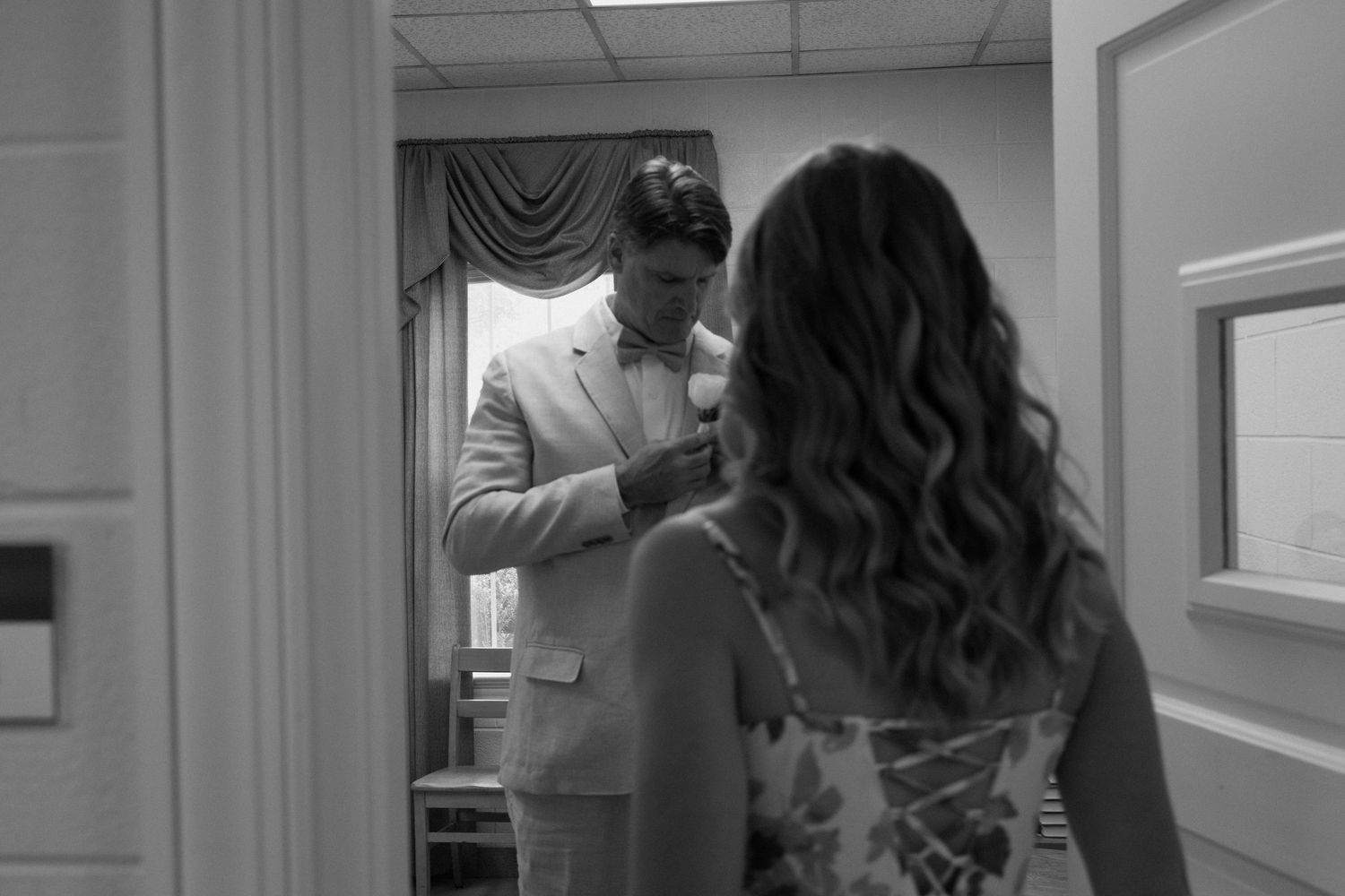 A sequence of four black and white photos showing two people collaborating in what appears to be an office setting.