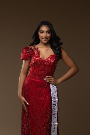 Young woman in red sequin gown wearing a Teen Kay Latina sash, posing confidently against a brown background.