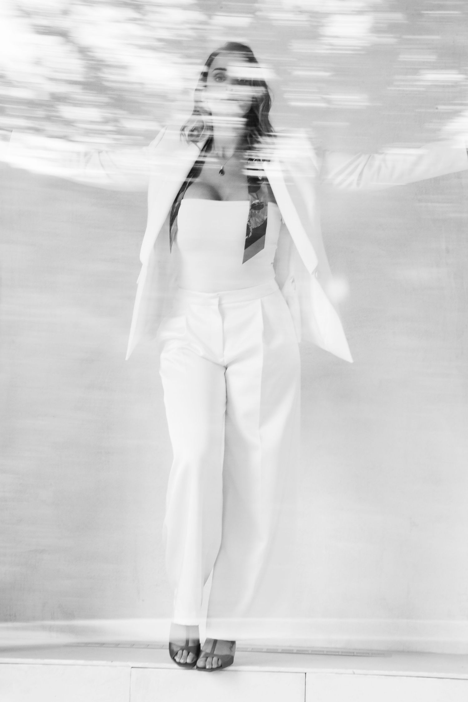 Artistic black and white photography series with ethereal water effect and white clothing.