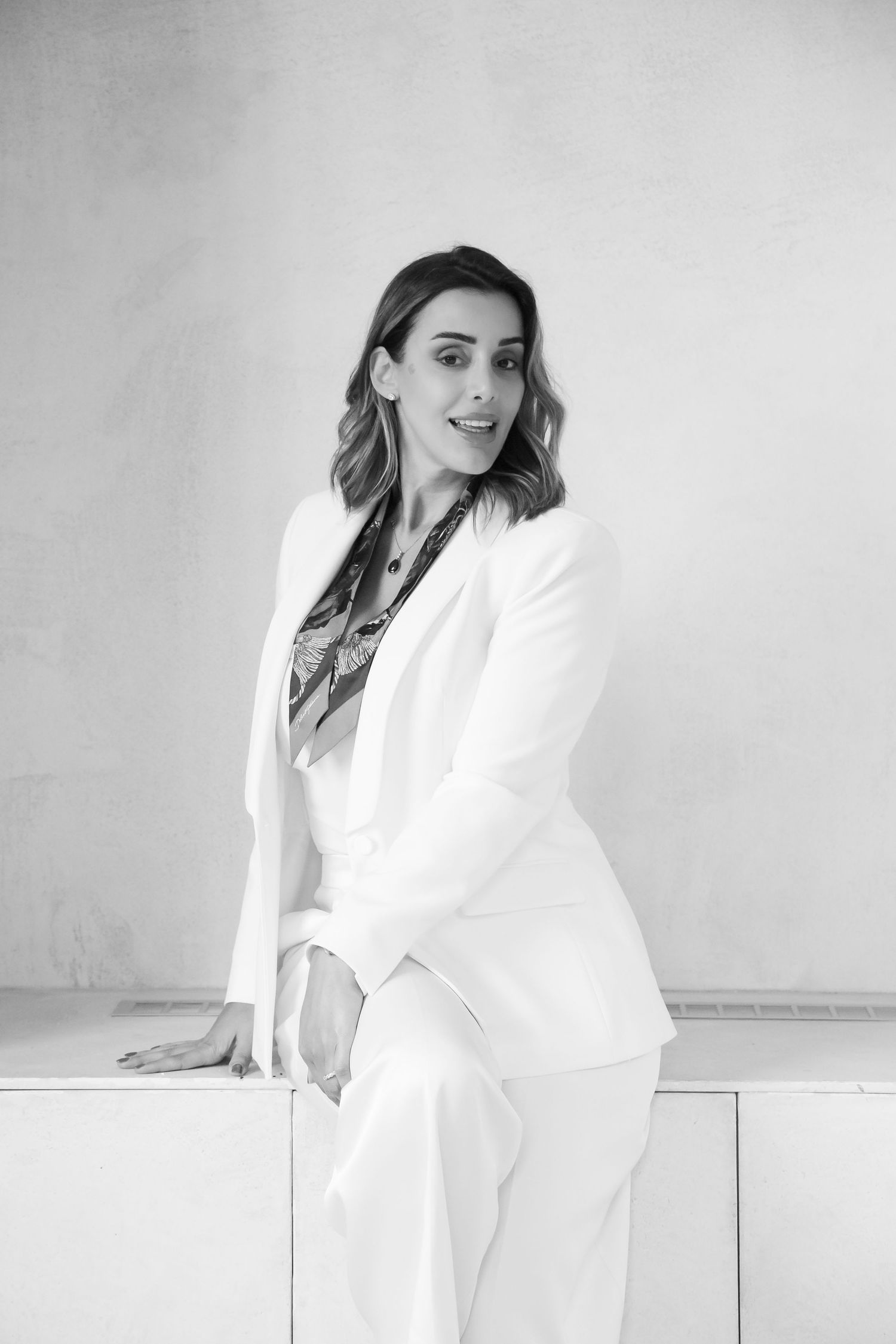 Minimalist fashion photography series in white featuring clean lines and modern styling.