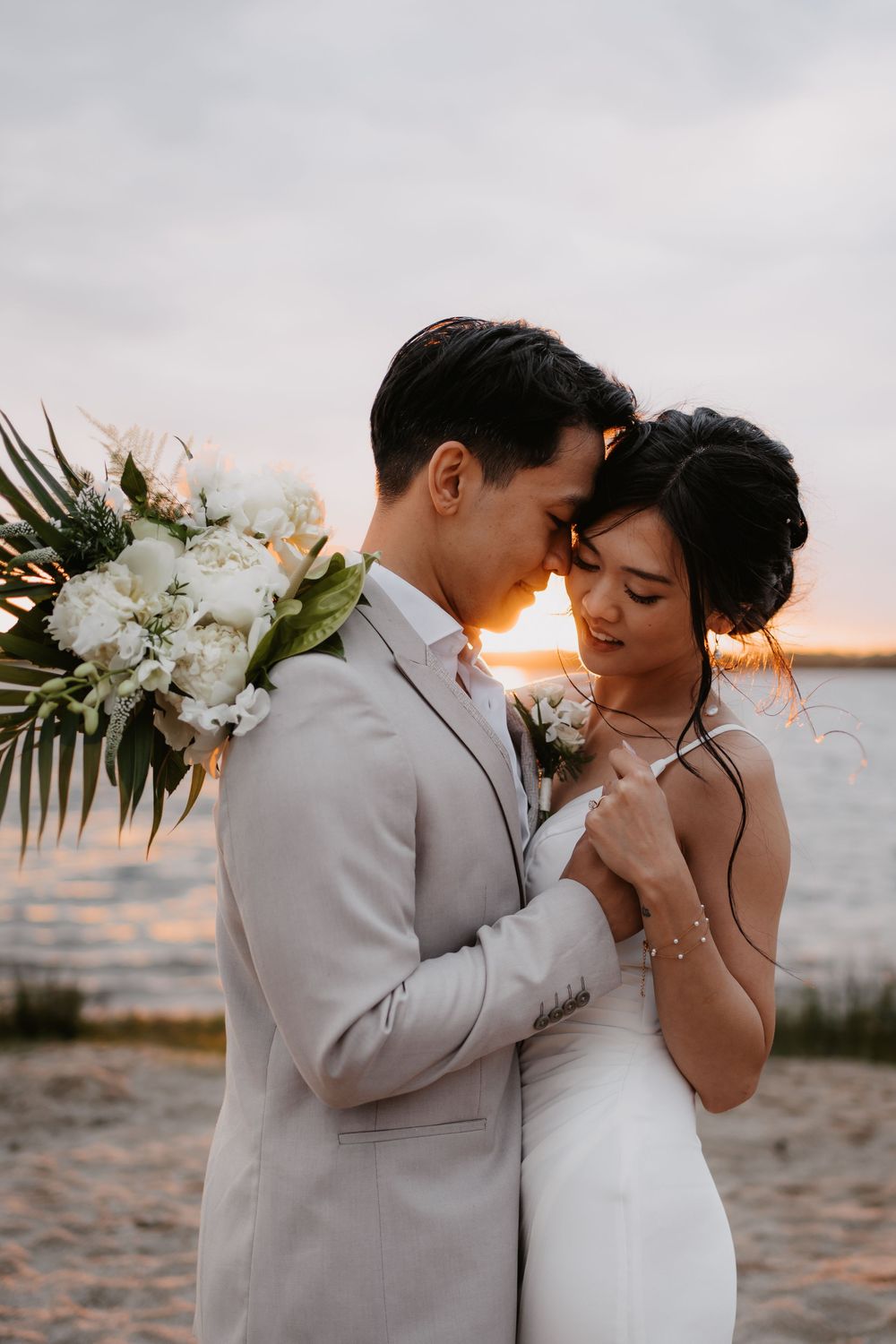 A romantic beach wedding photoshoot sequence showing tender moments between newlyweds at sunset.