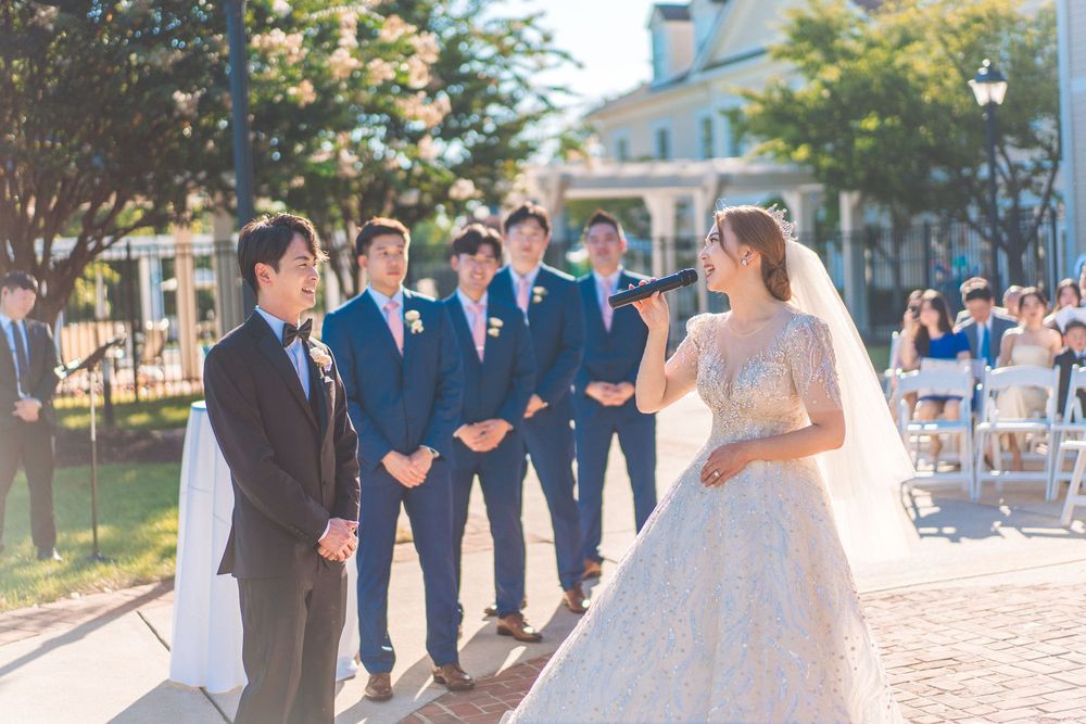 Wedding ceremony in progress with groomsmen in blue suits watching the bride.