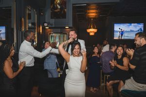 Bride dancing with wedding guests during a reception at The Coffee Grind in Massapequa