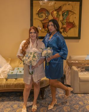 Group wearing matching robes posing together before a wedding ceremony.