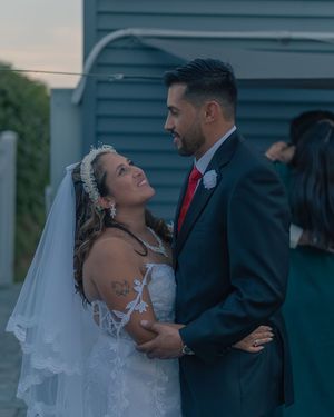 A couple shares laughter and joy during their outdoor wedding celebration.