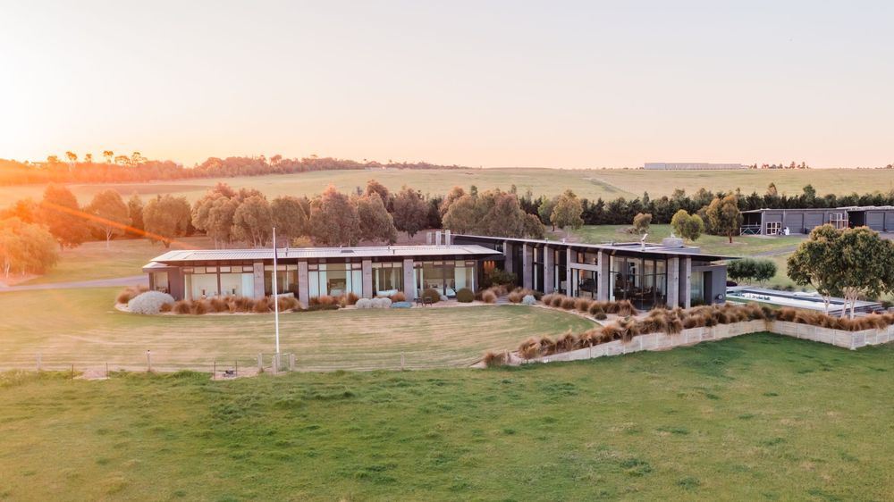 Panoramic sunset view of modern residential development in rural landscape.