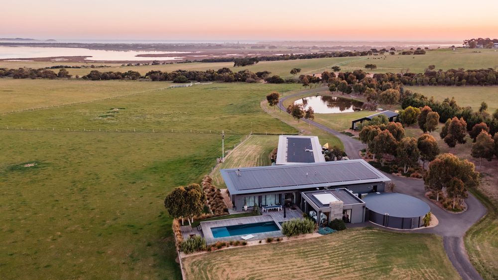 Aerial panorama of rural property development with modern architectural designs.