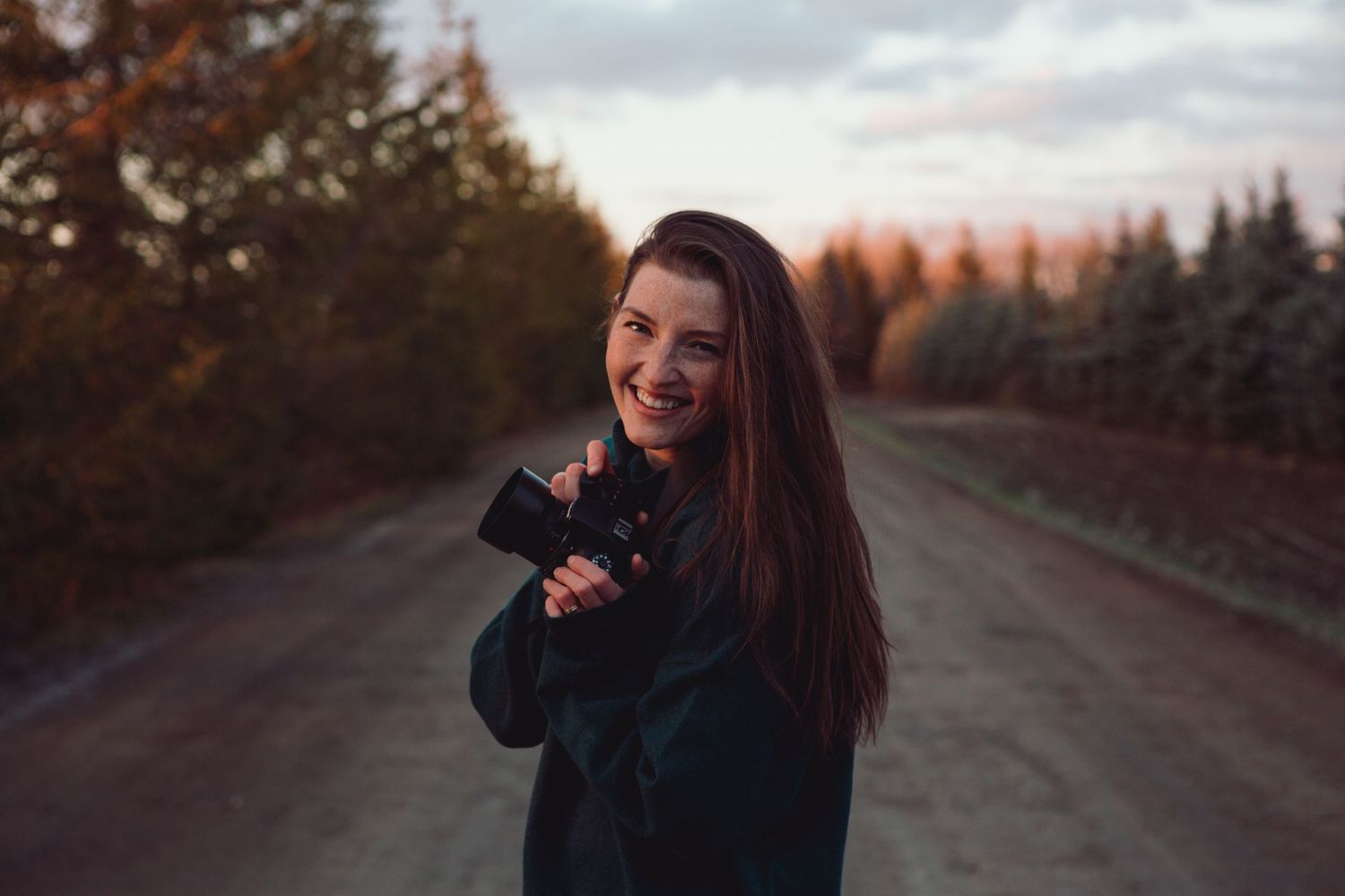 Romantic couple sharing tender moments on a scenic rural road during golden hour.