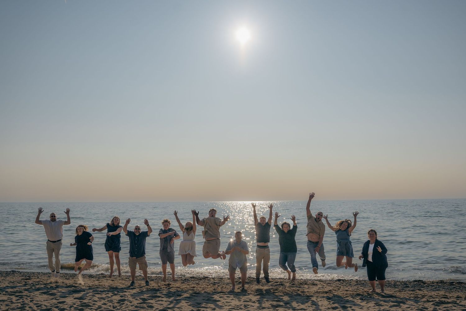 Extended family group photo at South Haven beach during sunset with Lake Michigan in the background