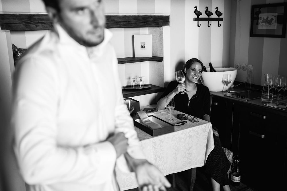 Black and white photo of preparations in a rustic kitchen setting.