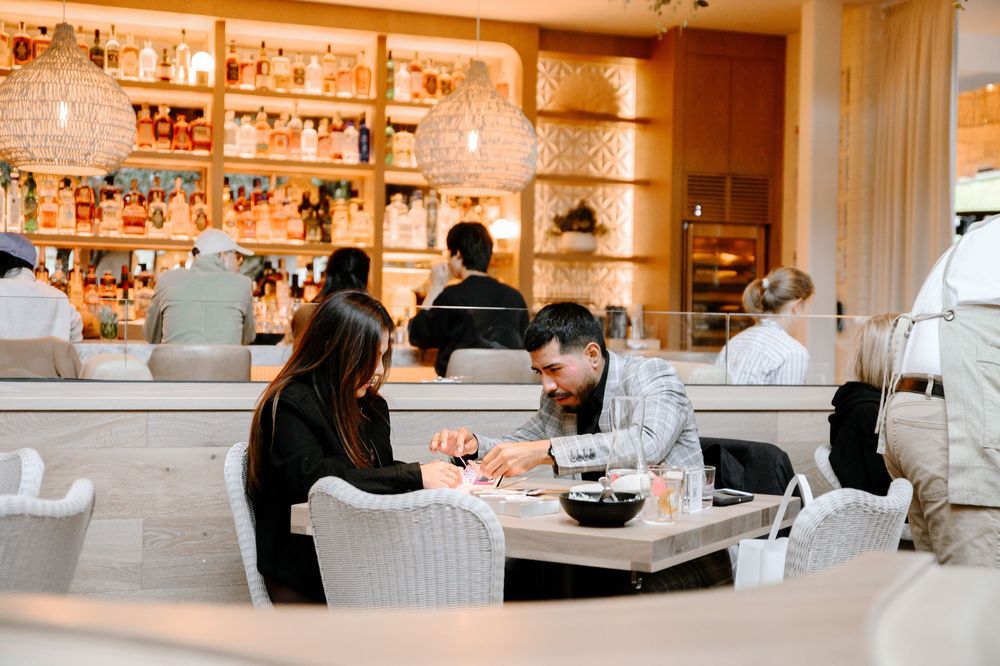 Upscale dining room with illuminated bar shelving and comfortable seating arrangements.