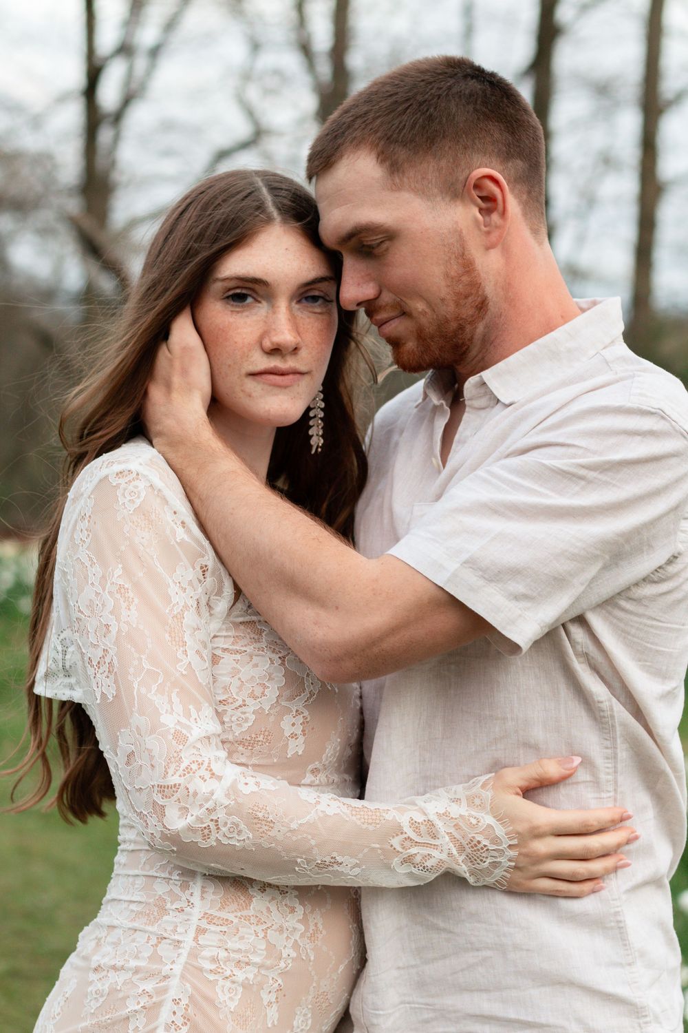 An intimate series of romantic photos showing a couple embracing outdoors among bare trees in wintertime.