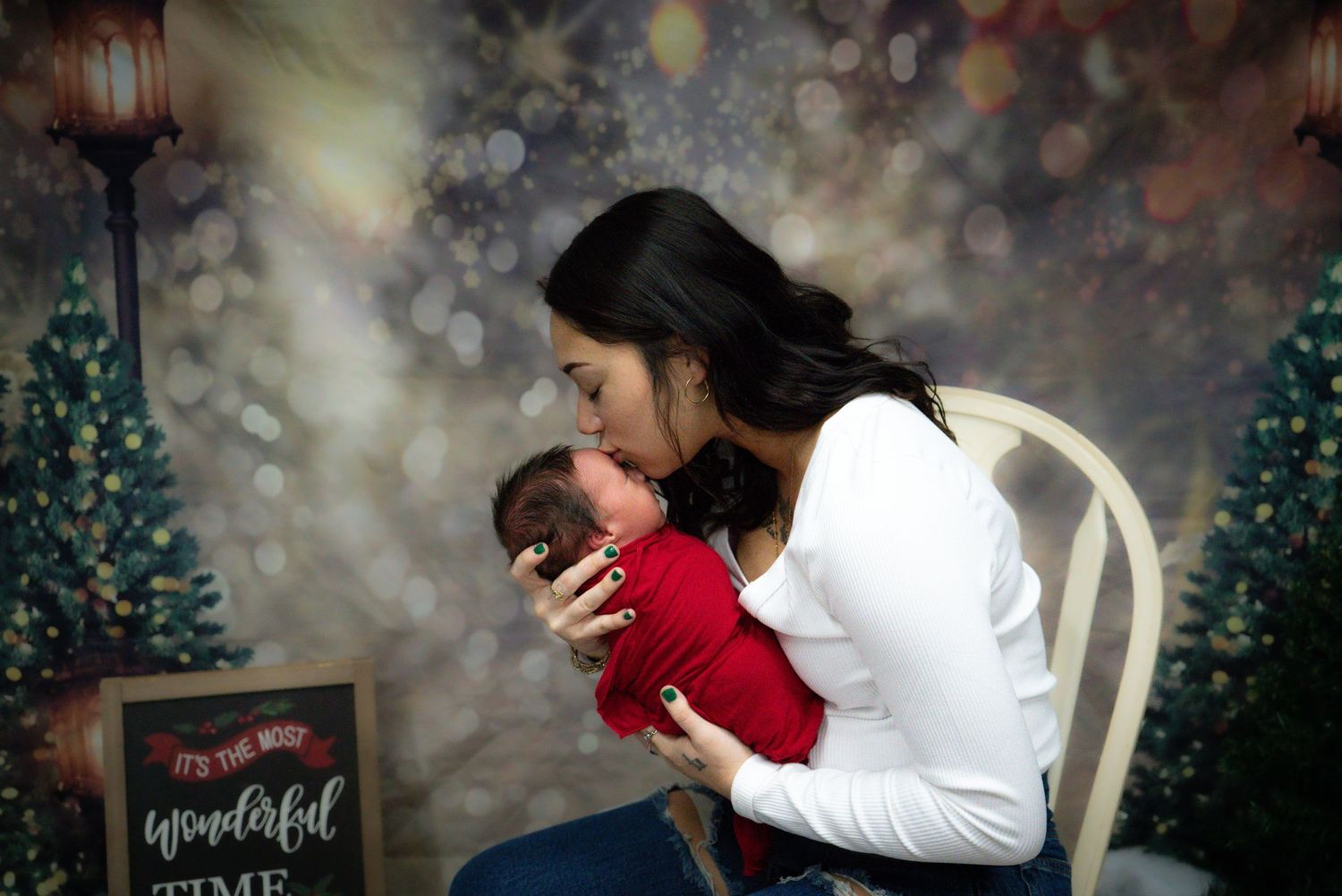 Winter holiday portrait scene with Christmas trees and bokeh lighting effects.