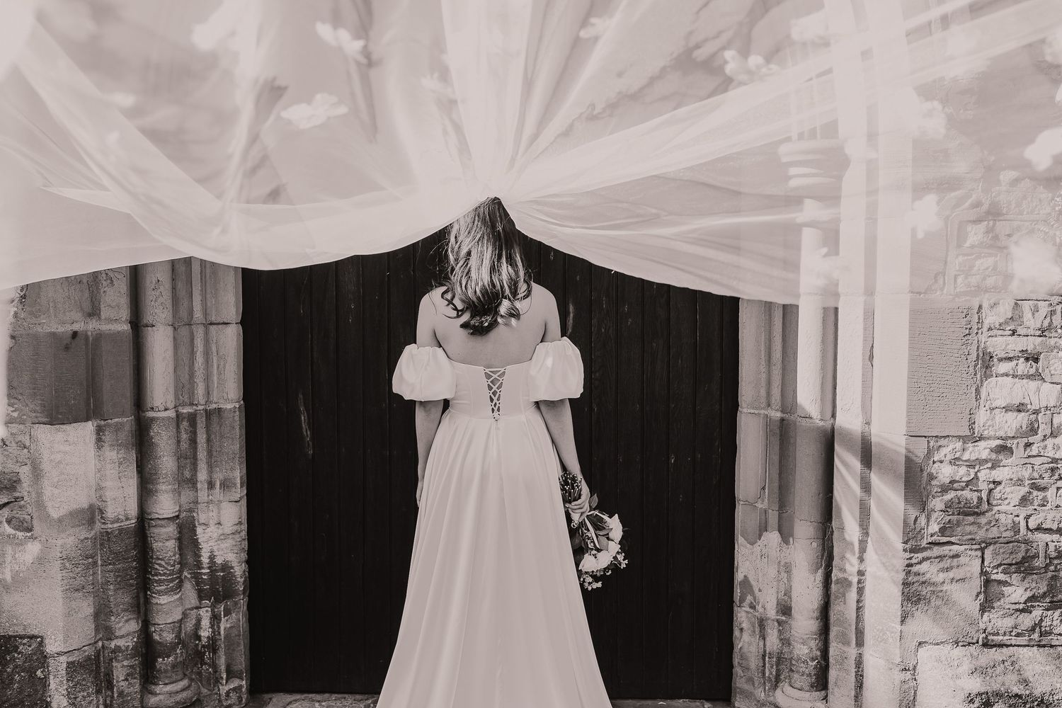 Elegant wedding ceremony setup with flowing white fabric and stone backdrop. Photographer. Hull. East Yorkshire. Photography
