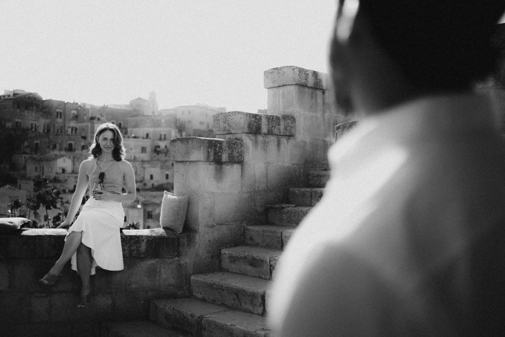 Black and white film photographs show a series of dreamy landscapes with figures walking in misty outdoor settings.