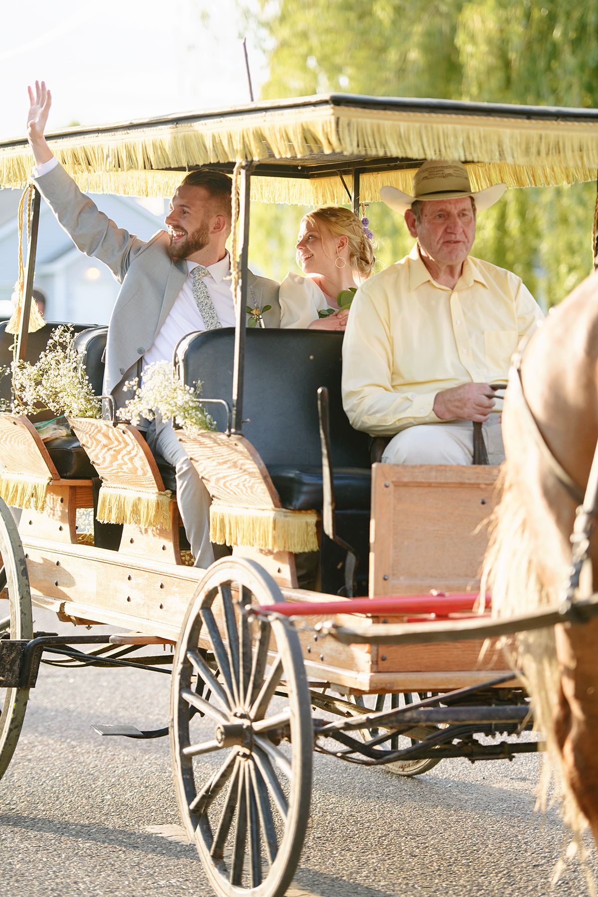 Blackfoot wedding photographer ShutterGirl send off with horse and carriage at backyard wedding in Blackfoot idaho