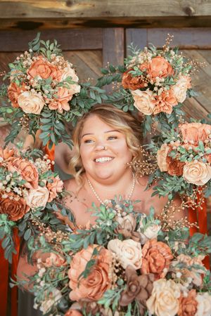 Beautiful floral arrangement with peach roses and eucalyptus frames wedding decorations.