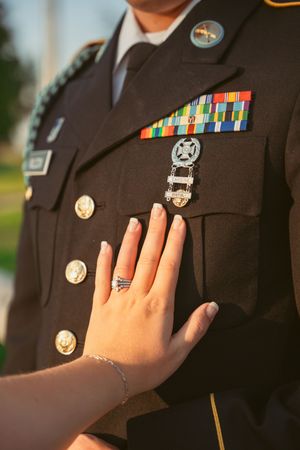 Close-up of military service medals and decorations on a dark uniform jacket.