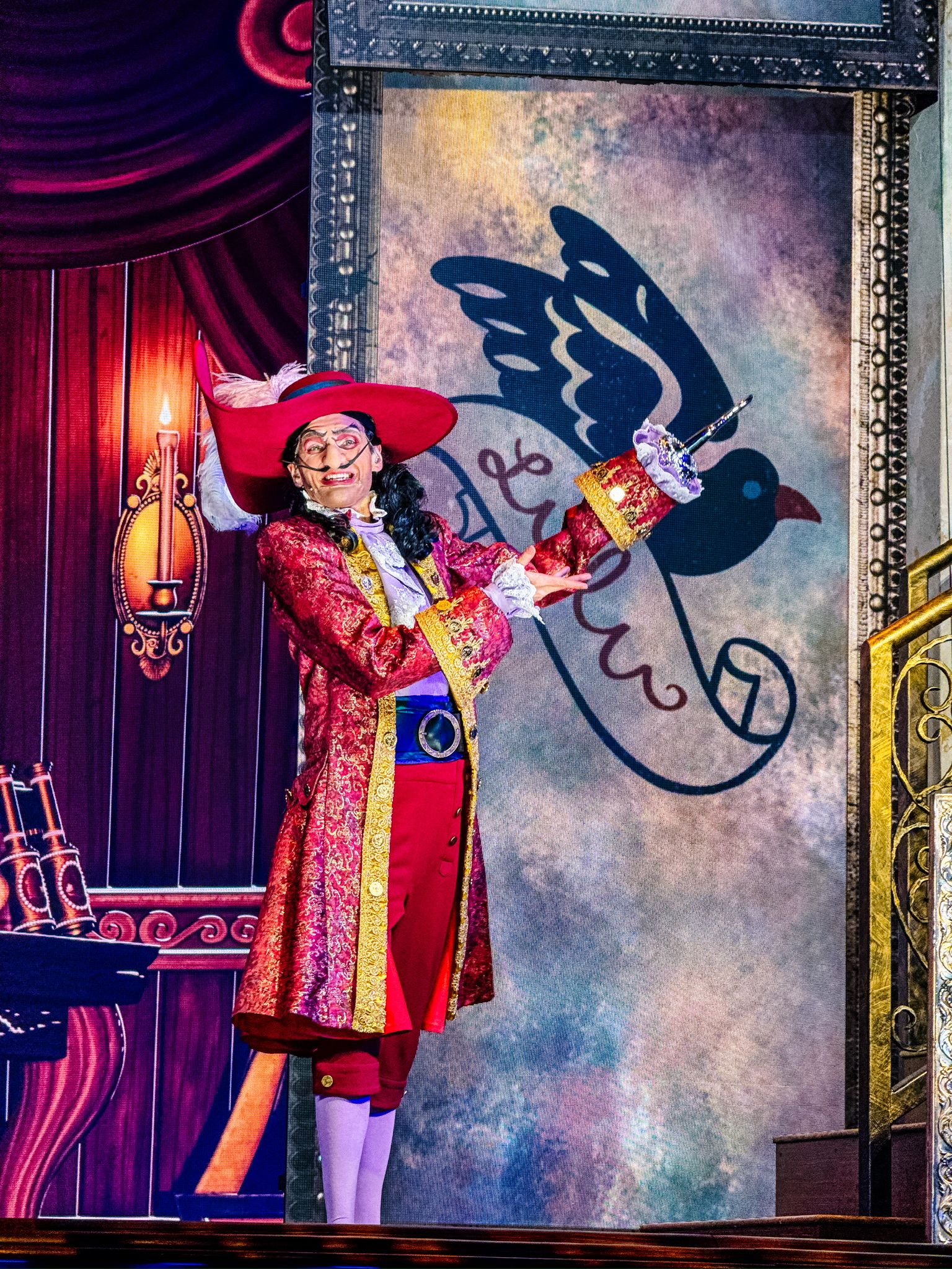 Theatrical performance with dramatic shadow projection against vintage-styled backdrop.
