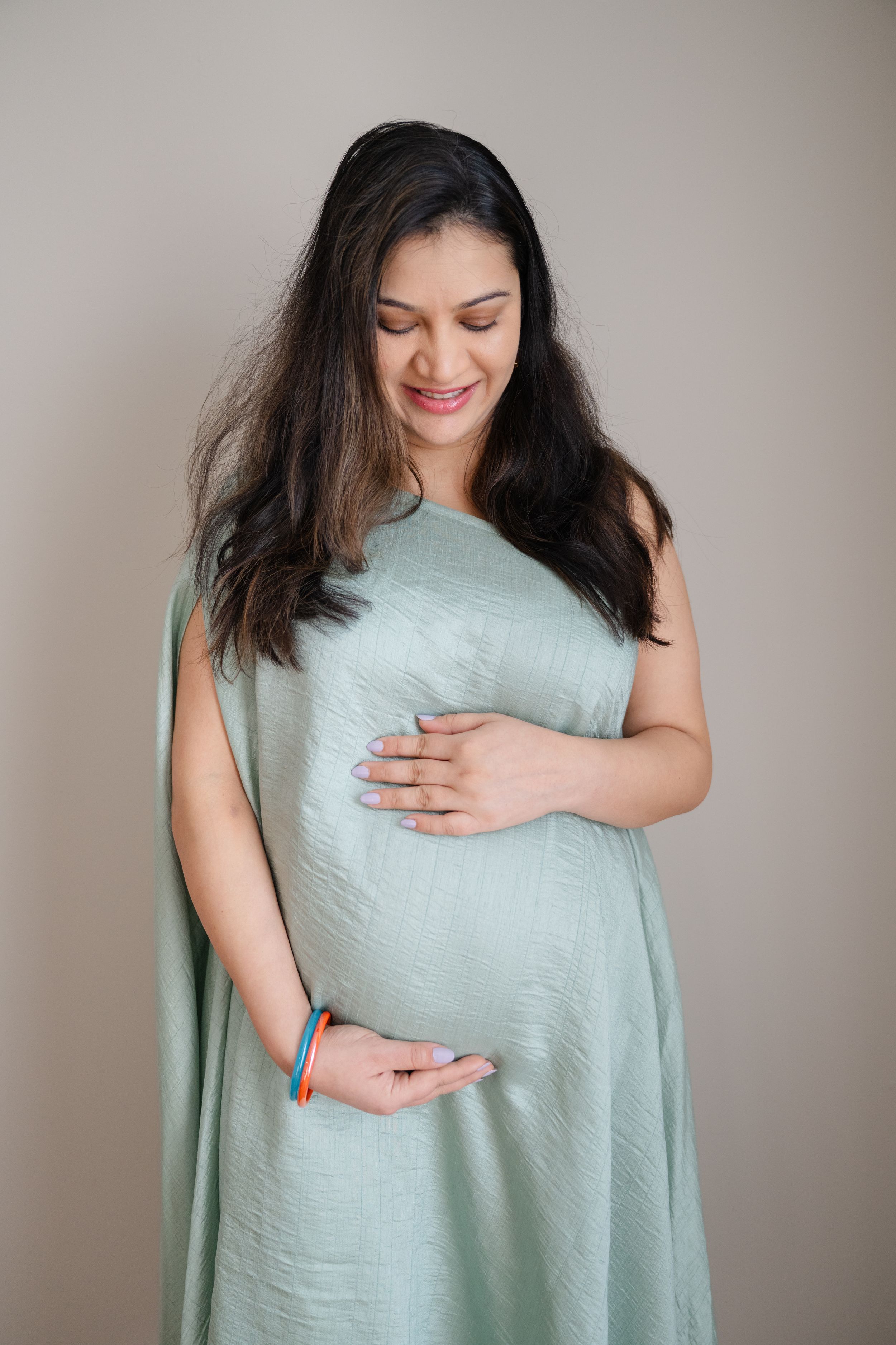 Pregnant mom holding her belly in a dress captured by maternity photographer Phoebe Lee Photo who is based in Toronto, Ontario.