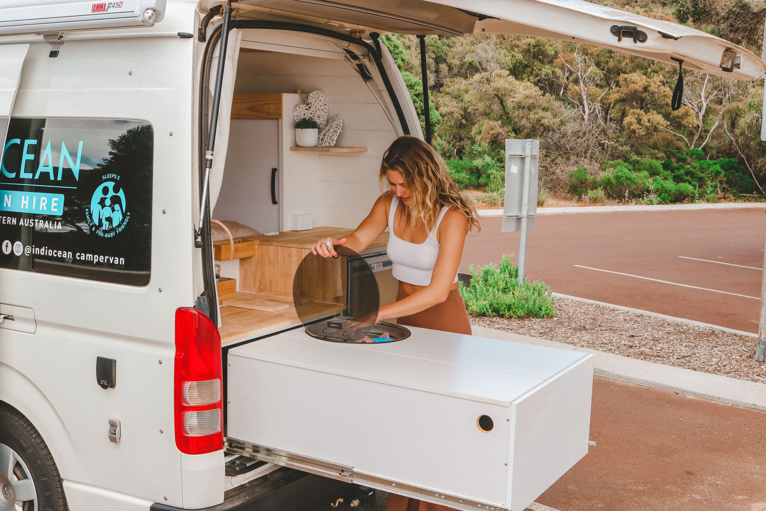 Storage drawer organization inside custom camper van conversion.
