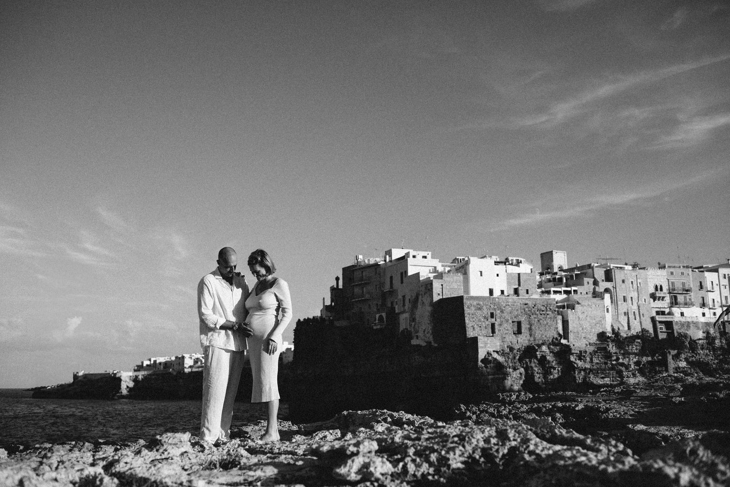A monochromatic view of ancient stone structures and ruins along the skyline in black and white photography.
