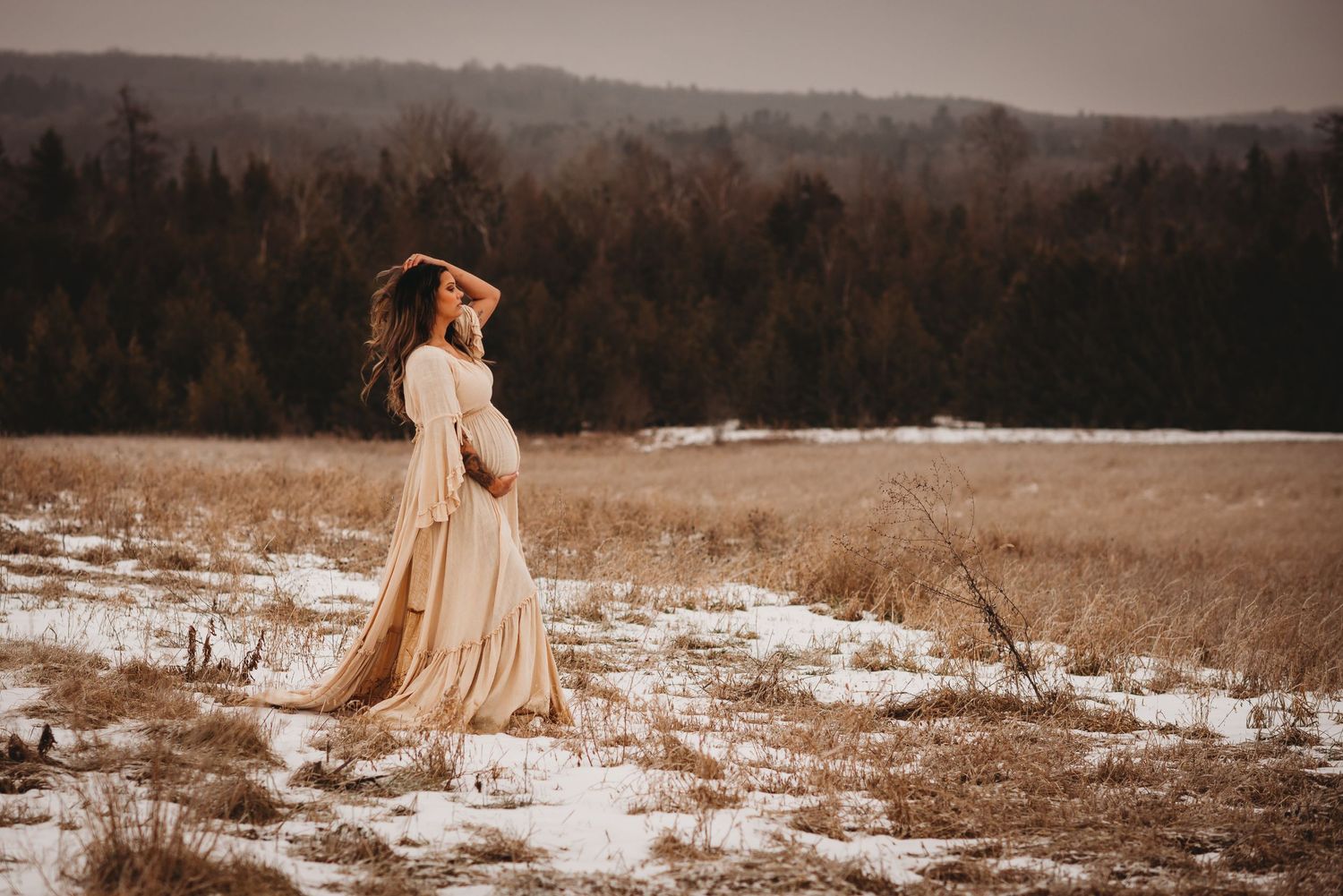 Expectant mother modeling a flowing gown during a maternity photography session in Kawartha Lakes.