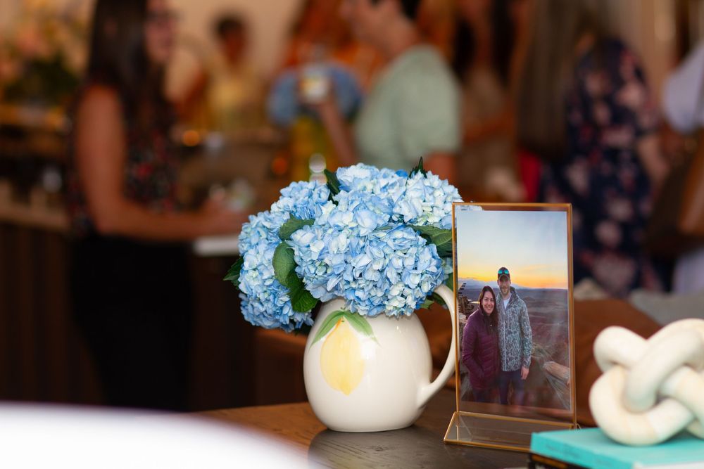 Decorative blue hydrangea flowers arranged in a white vase with soft lighting.