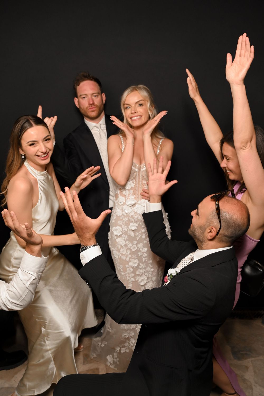 Elegant wedding portrait of bride and guests with a black background at Atzaro Ibiza.