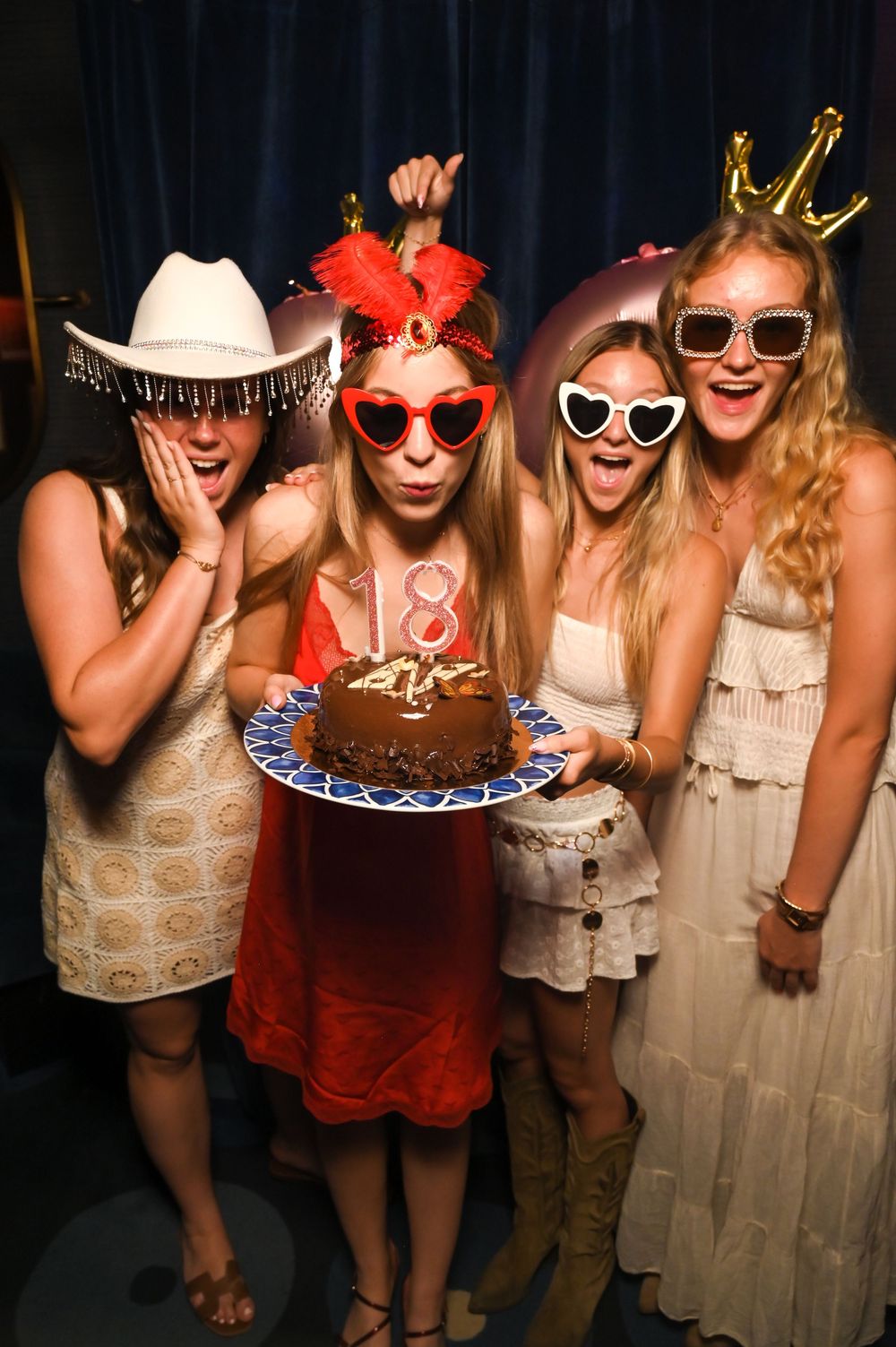 Birthday Girl and Guests posing for the retro photo booth with the cake at a luxury birthday celebration at Mongibello Ibiza.