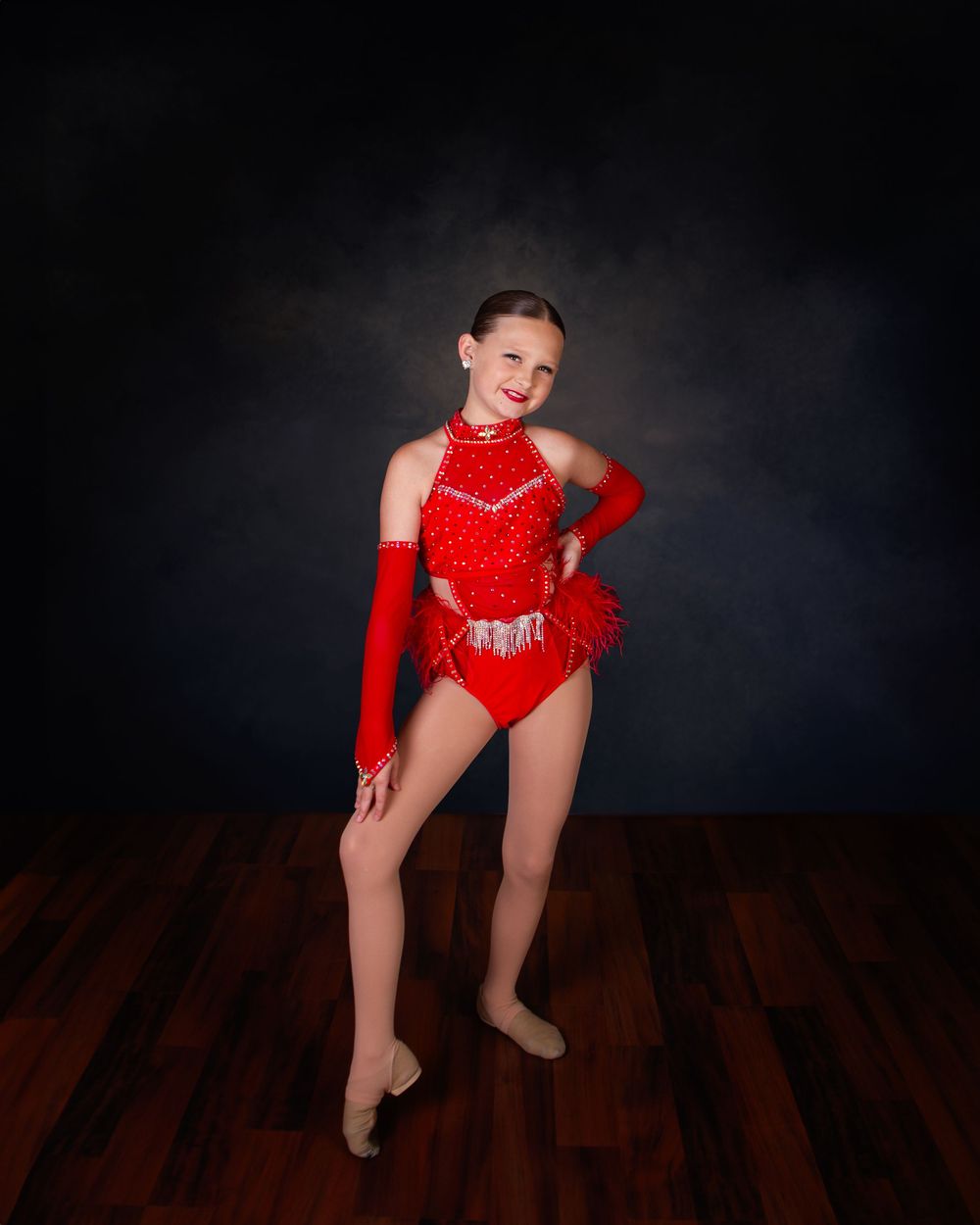 A series of dance poses in a red sequined leotard against a dark background showing graceful movements.