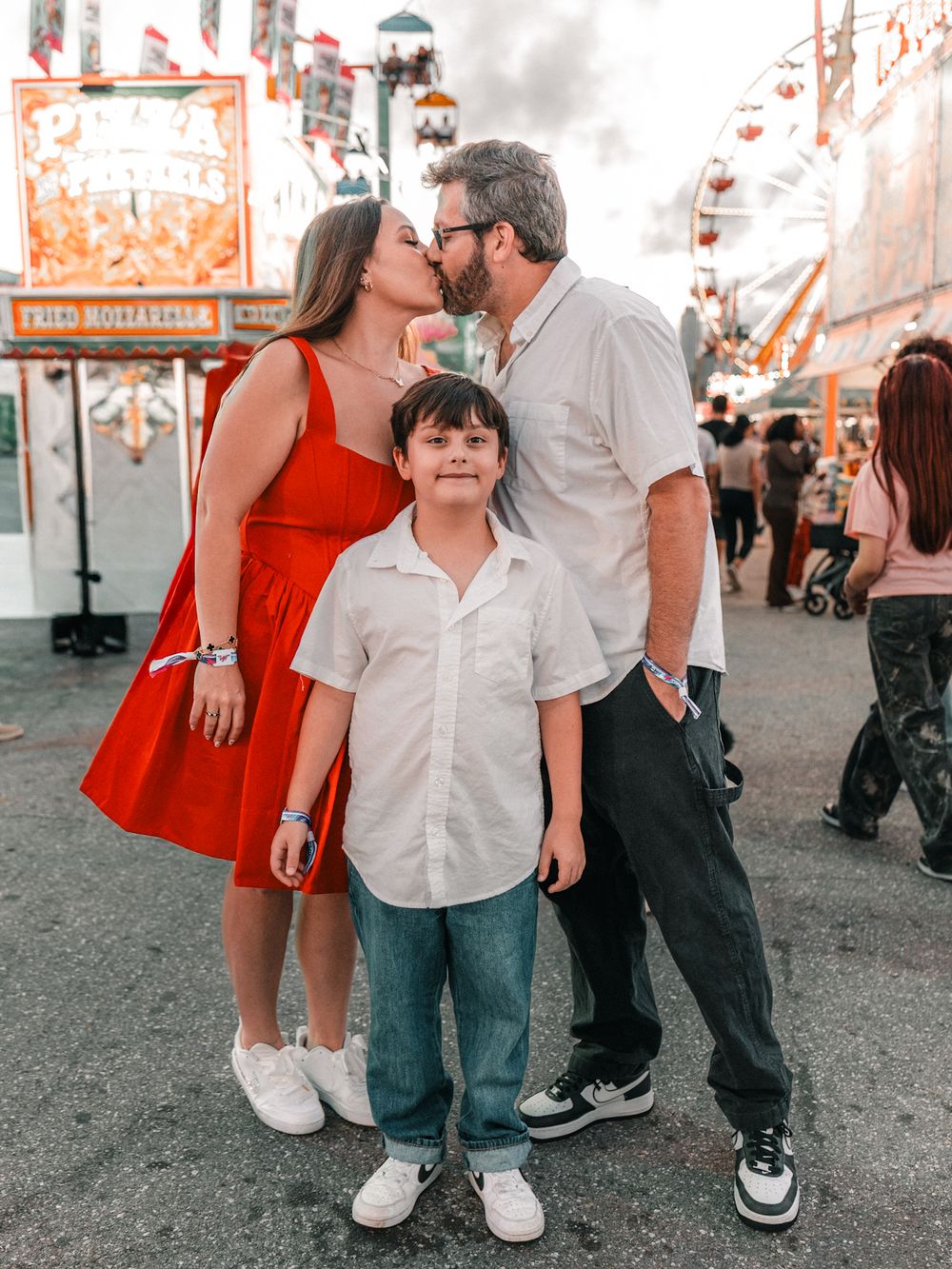 Candid carnival engagement photos showing legs and shoes of couples in vintage style filter.