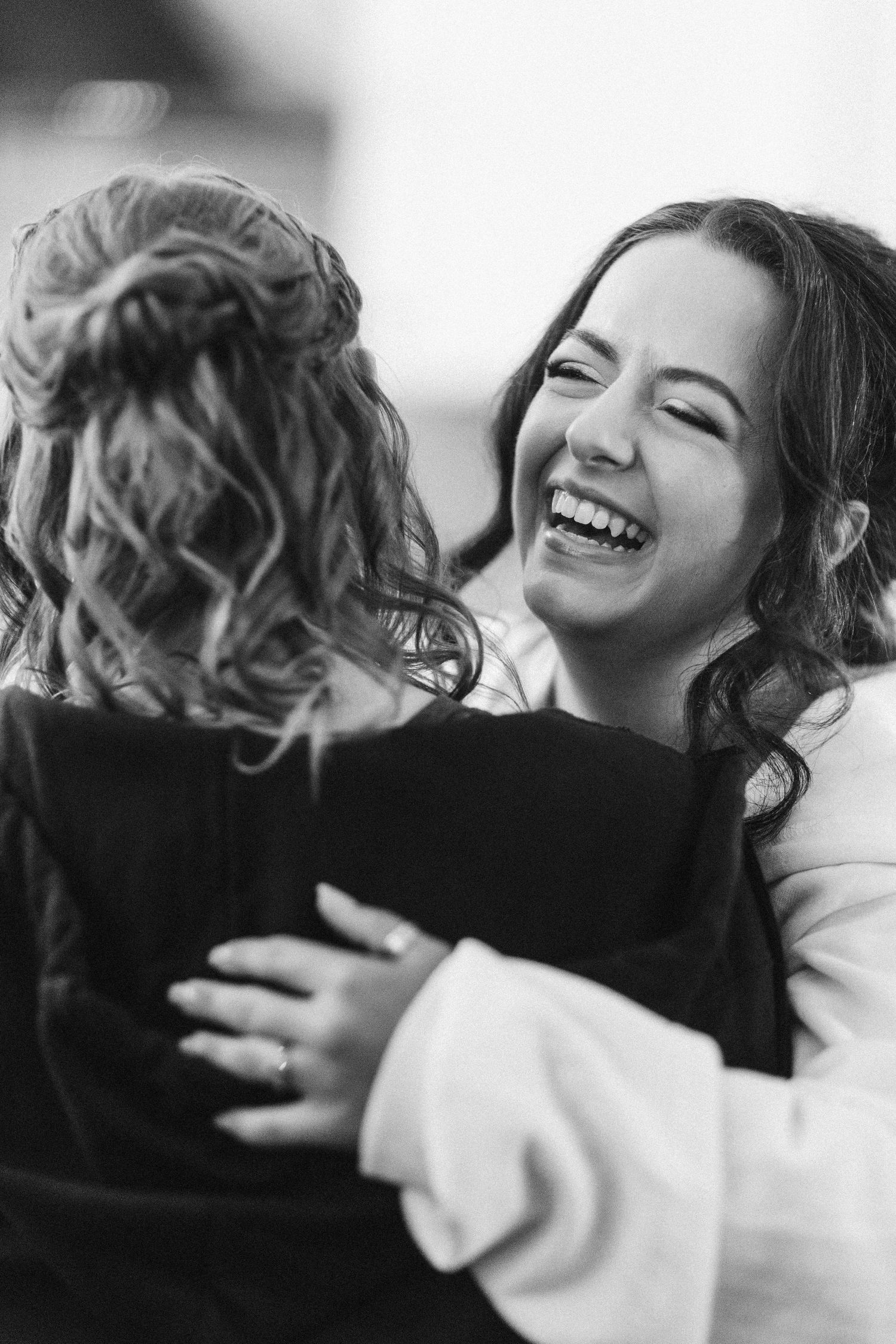A series of black and white photos showing joyful laughter and genuine emotional moments.