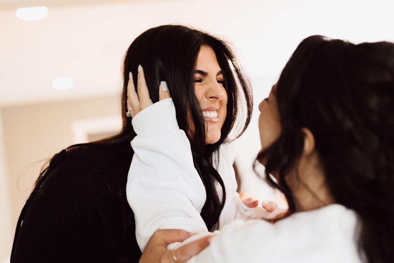 A series of candid shots showing playful interaction and laughter in a light-filled setting.
